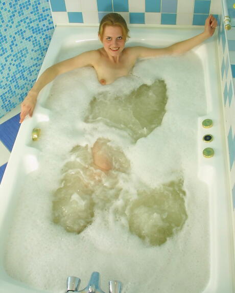 Slender teen Luba reveals her butt and hairy pussy in bathroom